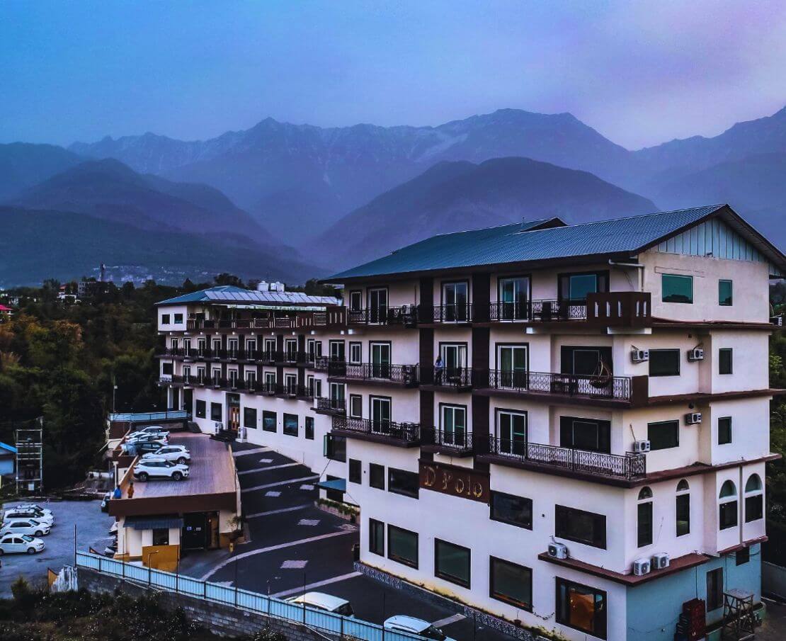 Romantic couple embraces amidst the breathtaking landscapes of Dharamshala, the perfect backdrop for their dream destination weddings in Dharamshala.