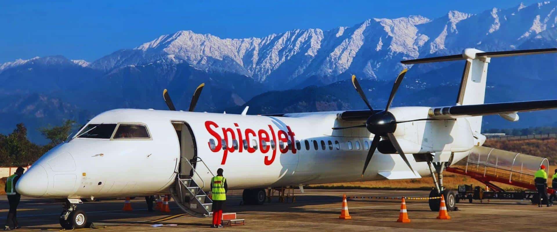 Stunning aerial view of the Himachal Pradesh Cricket Association Stadium, Dharamshala with the majestic Dhauladhar mountains in the background — a world-renowned cricket venue surrounded by Himalayan beauty.